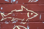 Yellow fish on red wall